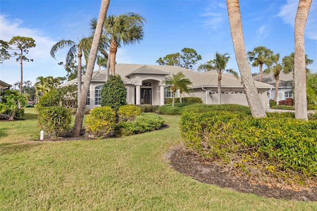 view of front of property featuring a garage and a front lawn