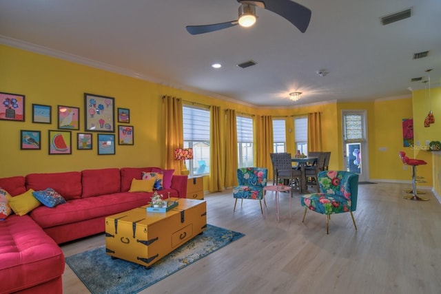 living room with ceiling fan, light hardwood / wood-style flooring, and crown molding