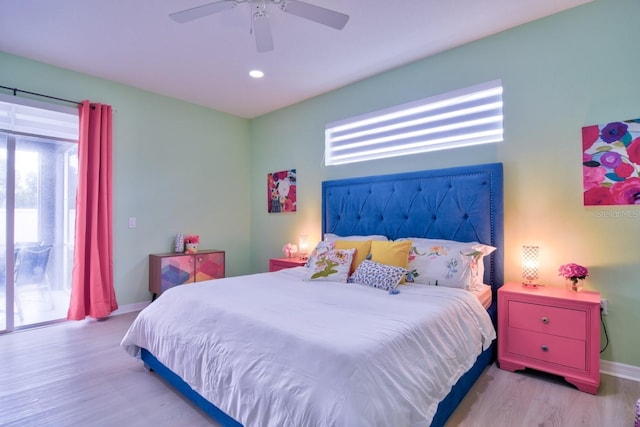 bedroom featuring ceiling fan, light hardwood / wood-style flooring, and multiple windows