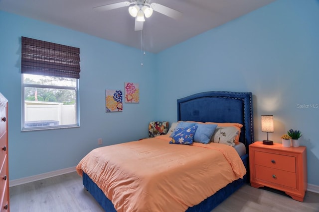 bedroom with light wood-type flooring and ceiling fan