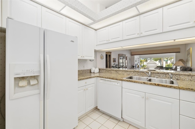 kitchen with white cabinetry, sink, light tile patterned flooring, and white appliances