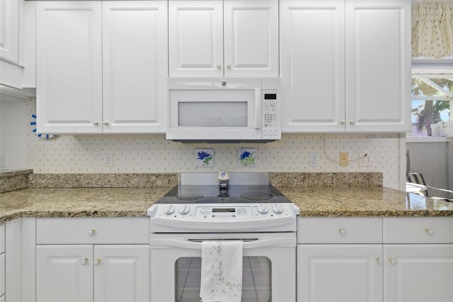 kitchen featuring white cabinetry, white appliances, light stone countertops, and tasteful backsplash