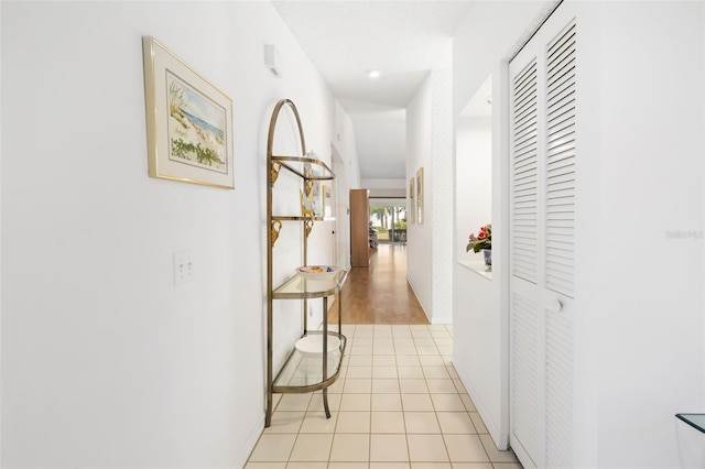 hall with light tile patterned floors