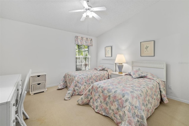 carpeted bedroom with a textured ceiling, vaulted ceiling, and ceiling fan