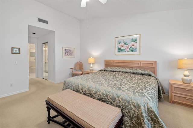 carpeted bedroom with ceiling fan and ensuite bath