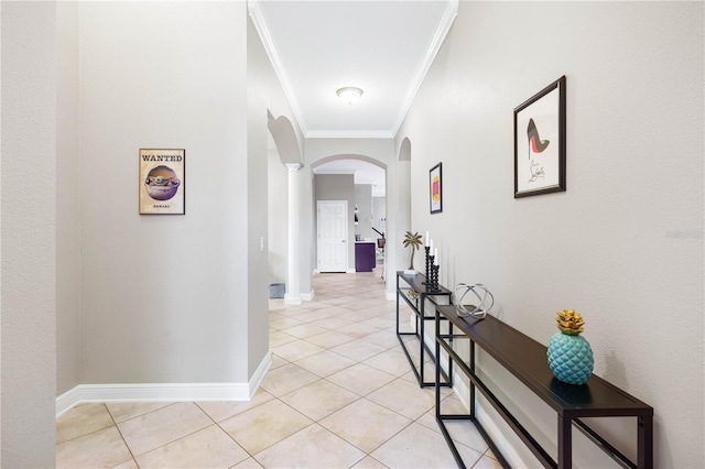 hallway with light tile patterned floors, crown molding, and ornate columns