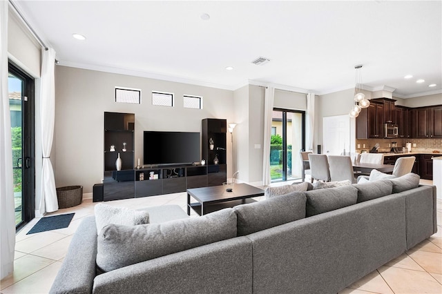 living room with light tile patterned floors and ornamental molding