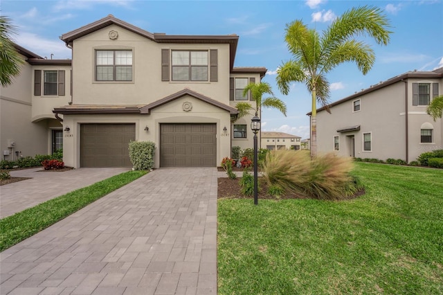 view of front of property with a garage and a front lawn