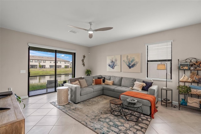 tiled living room featuring ceiling fan