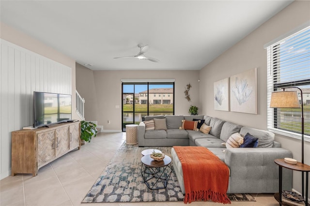 tiled living room featuring ceiling fan