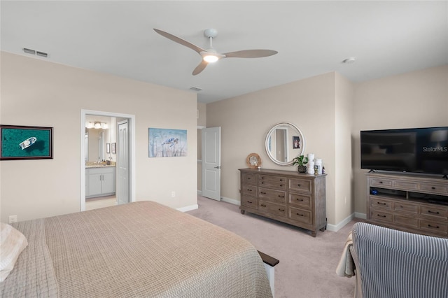 carpeted bedroom with ceiling fan and connected bathroom