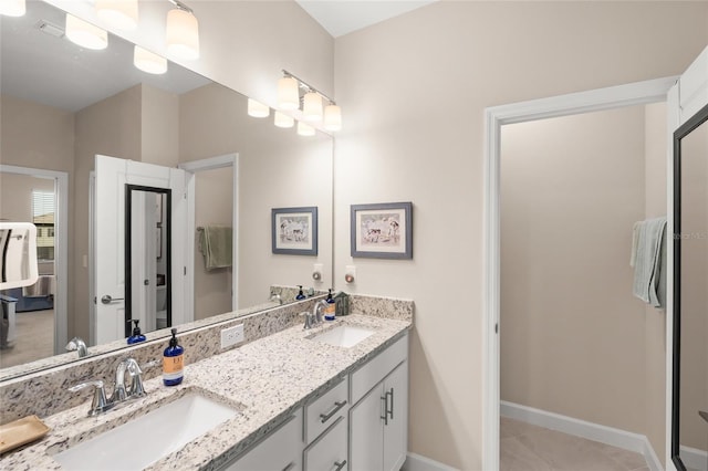 bathroom with tile patterned floors and vanity