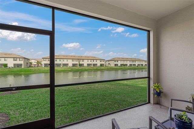 unfurnished sunroom with a water view