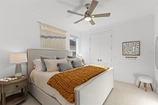 bedroom featuring light colored carpet, a closet, ceiling fan, and ornamental molding