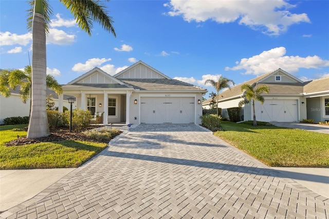 view of front of property featuring a garage and a front lawn