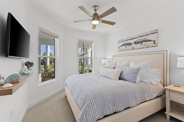 carpeted bedroom featuring ceiling fan and ornamental molding