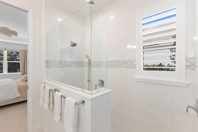 bathroom with tiled shower and a wealth of natural light