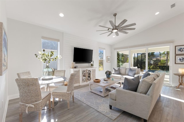 living room with hardwood / wood-style flooring, lofted ceiling, and ceiling fan