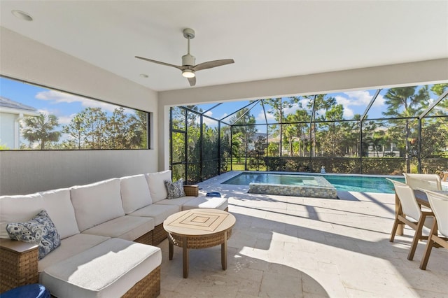 view of swimming pool with an outdoor living space, a patio area, and a lanai