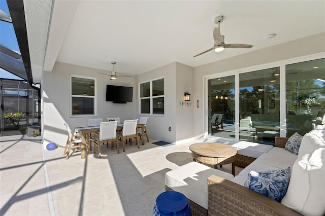 view of patio / terrace with ceiling fan, glass enclosure, and an outdoor hangout area