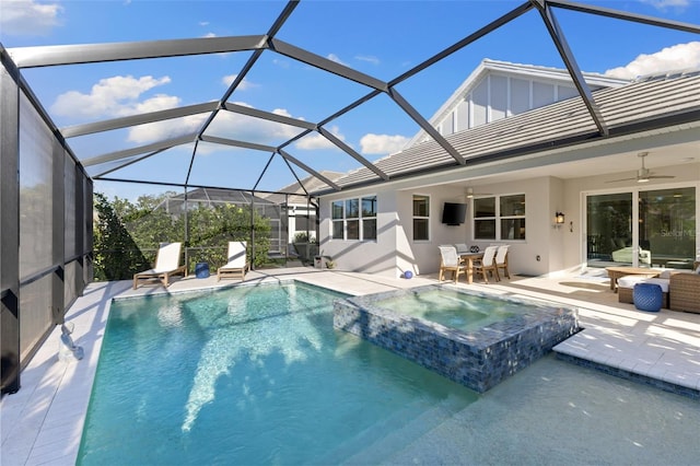 view of pool with glass enclosure, an in ground hot tub, a patio area, and ceiling fan