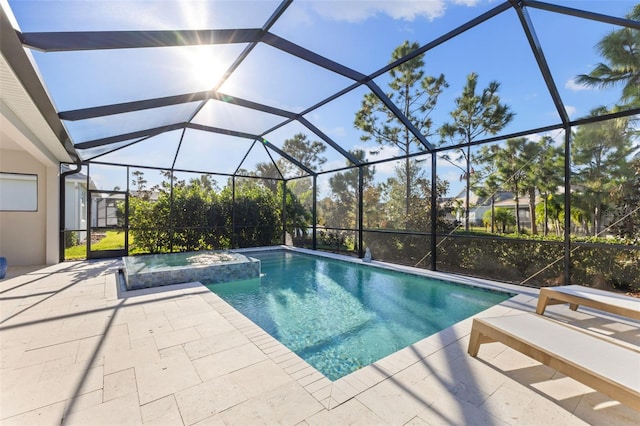 view of swimming pool featuring an in ground hot tub, a patio area, and a lanai