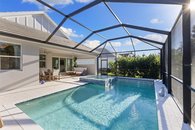 view of swimming pool featuring an outdoor living space, an in ground hot tub, a patio, and a lanai