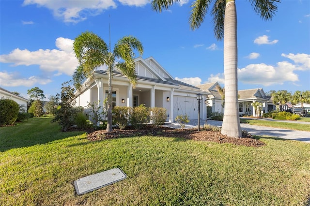 view of front of home with a garage and a front lawn