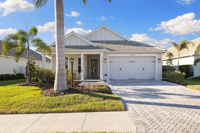 view of front of property with a garage and a front yard