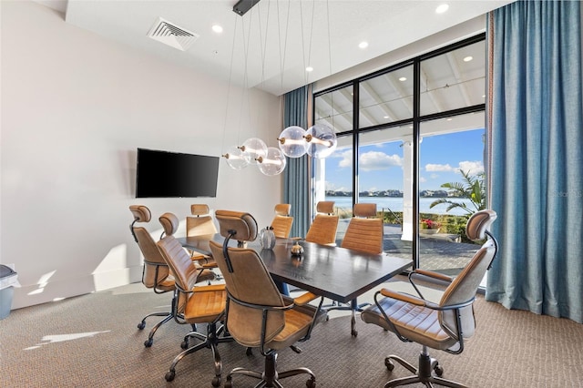 carpeted dining room with floor to ceiling windows