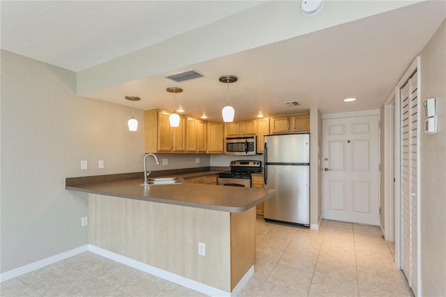 kitchen featuring appliances with stainless steel finishes, sink, hanging light fixtures, kitchen peninsula, and light tile patterned floors