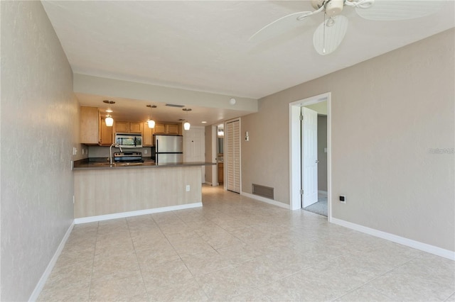 unfurnished living room with sink and ceiling fan