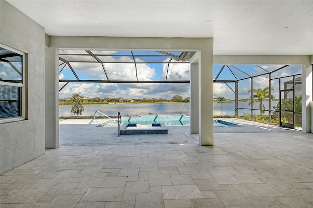 view of pool with a lanai, a water view, a patio area, and a jacuzzi