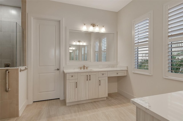 bathroom with vanity, tile patterned floors, and a tile shower