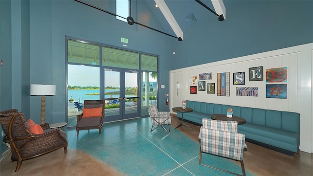 living room with beam ceiling, high vaulted ceiling, french doors, and a water view