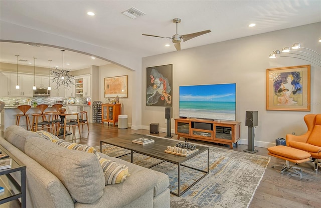 living room with light hardwood / wood-style floors and ceiling fan