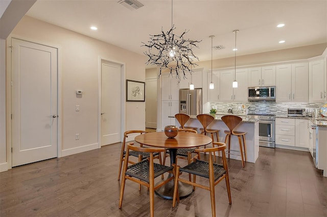 dining area with dark hardwood / wood-style flooring