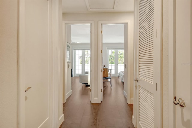 hallway with french doors and hardwood / wood-style floors