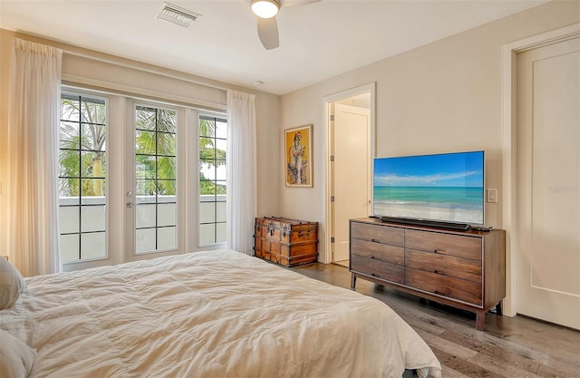 bedroom featuring ceiling fan, dark wood-type flooring, and access to exterior