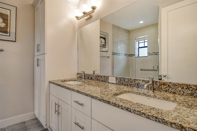 bathroom with tile patterned flooring, an enclosed shower, and vanity