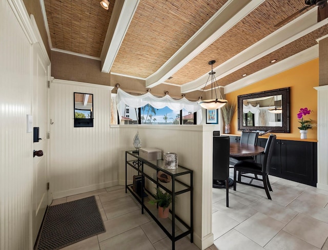 interior space with hanging light fixtures, lofted ceiling with beams, and light tile patterned flooring