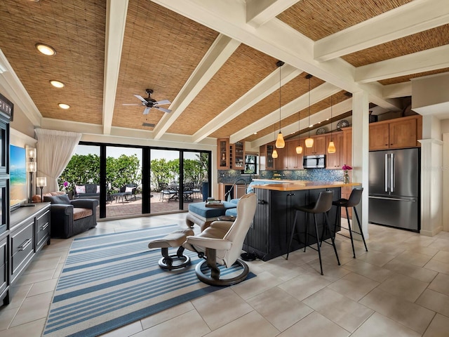 living room with light tile patterned floors and lofted ceiling with beams