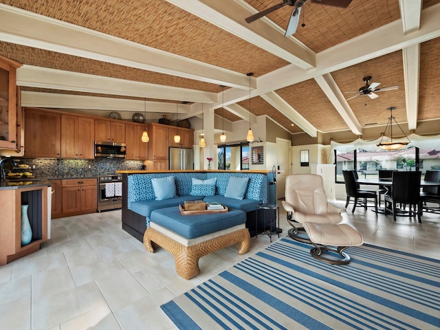 living room featuring light tile patterned floors, lofted ceiling with beams, sink, and ceiling fan