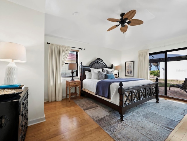 bedroom with hardwood / wood-style floors, ceiling fan, access to outside, and multiple windows