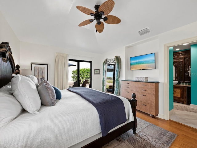 bedroom with ceiling fan, wood-type flooring, access to exterior, and connected bathroom