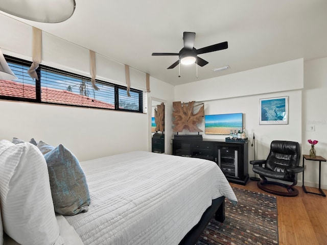 bedroom with wood-type flooring and ceiling fan