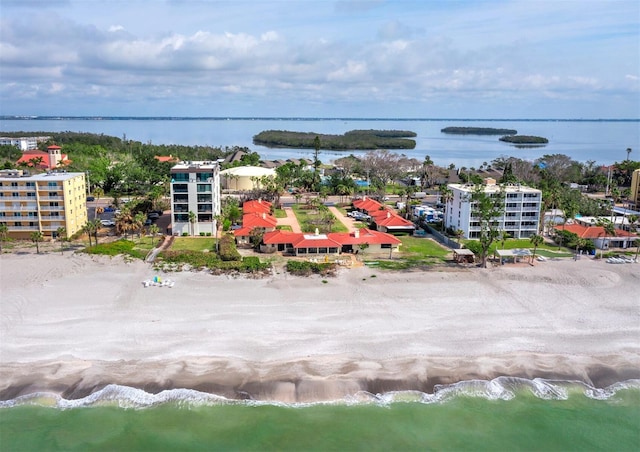 drone / aerial view with a water view and a beach view