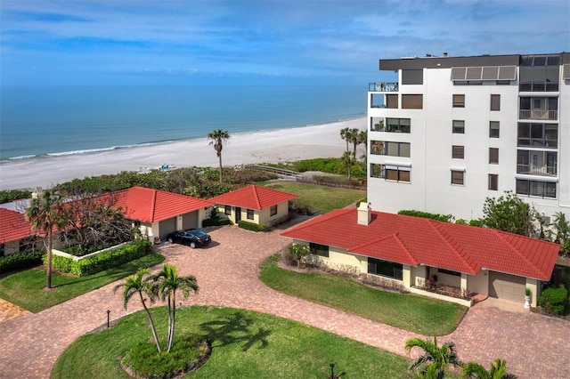 drone / aerial view with a beach view and a water view