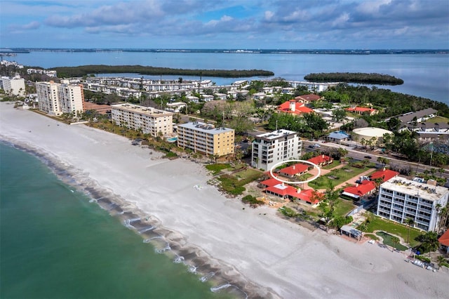 drone / aerial view featuring a water view and a view of the beach