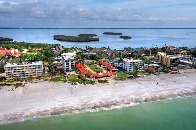 bird's eye view featuring a water view and a beach view